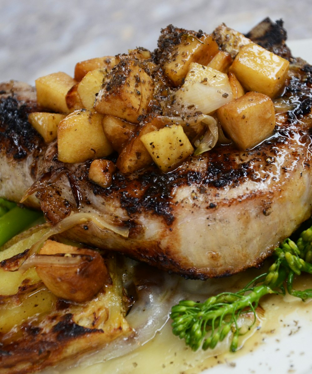 Fire-roasted pork chop glazed and charred, plated dark