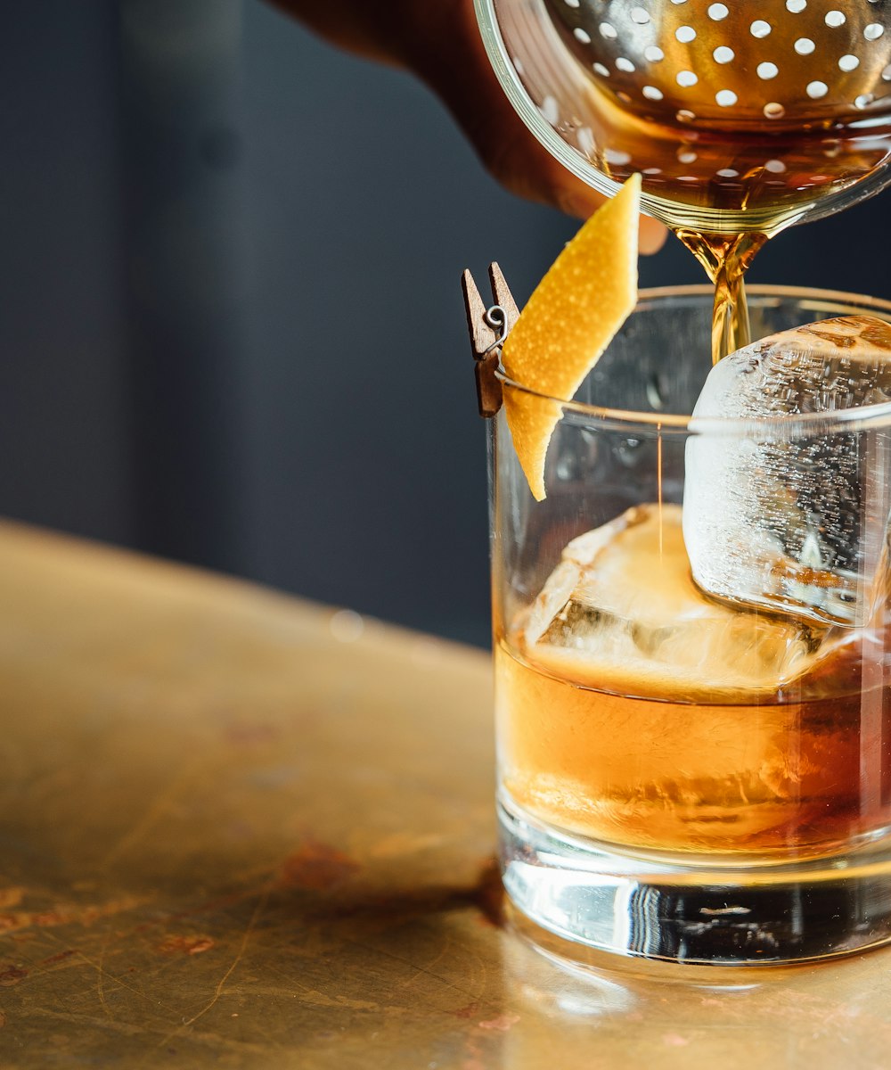 An old-fashioned cocktail with a large ice cube