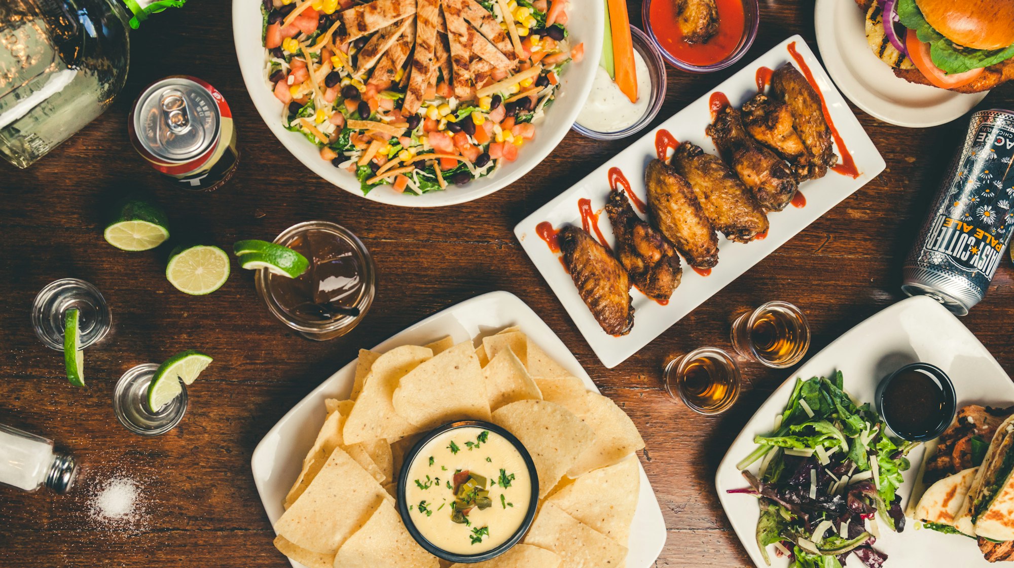 A spread of wood-fired sharing plates across a dark table